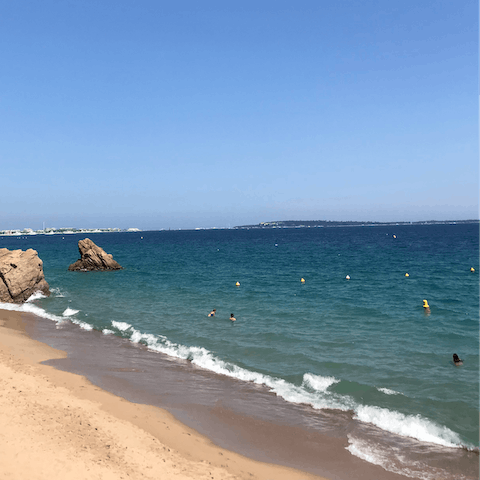 Listen to the waves lap the shore as you stroll along Midi Beach