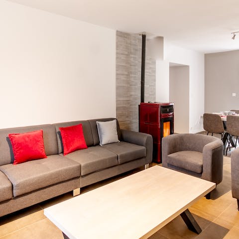 Kick back and relax on the comfy sofa in the living room, with the warmth of the pellet stove