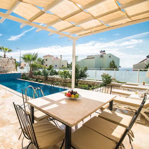 Dine poolside on the covered terrace
