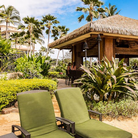 Sprawl out on the plush lounge chairs with a drink from the tiki bar