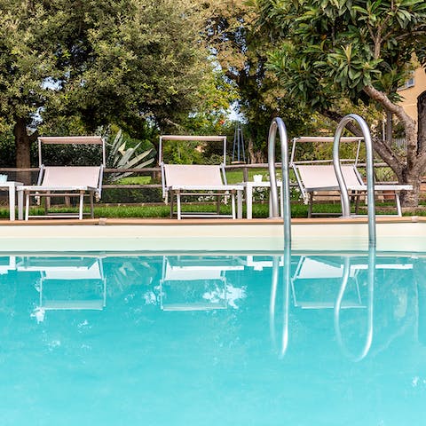 Spend sunny afternoons lazing in the pristine pool, surrounded by greenery