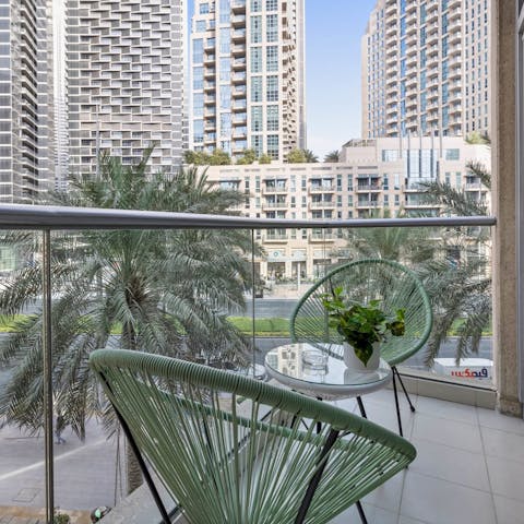 Enjoy an evening apéritif on the private balcony as Downtown Dubai bustles with life below