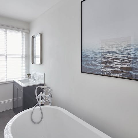 Sink into the deep bath tub and admire the artwork