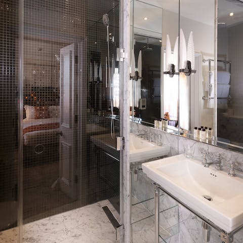 Rejuvenate in the walk-in shower with luxe marble interiors