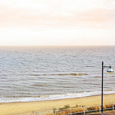 Watch the sunrise over the sea with Southwold Beach before you