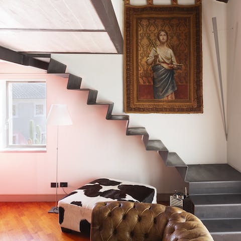 Descend the floating staircase to a chic living space