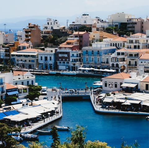 Explore cobblestone streets filled with pastel-coloured houses in Agios Nikolaos