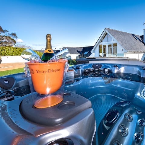 Sip champagne under the stars in the outdoor hot tub
