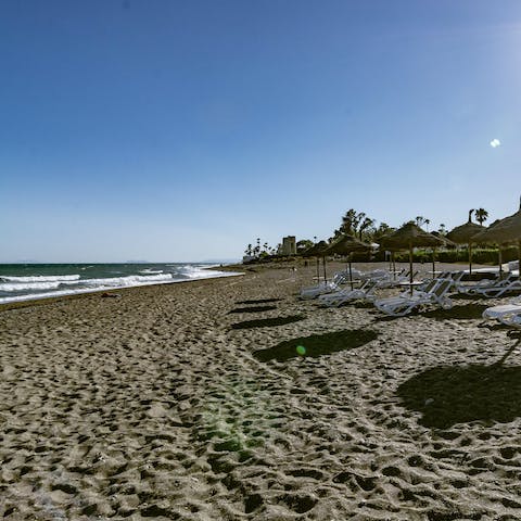 Walk along the sandy coast of Playa de San Pedro de Alcantara