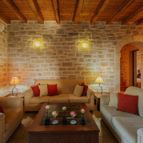 Socialise in the living room with its traditional beams and exposed stone walls