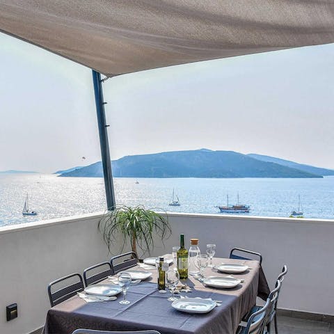 Dine against a backdrop of boats bobbing on the Adriatic