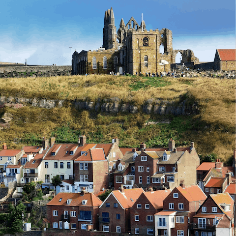 Visit the storied ruins of Whitby Abbey, a fifteen-minute walk away