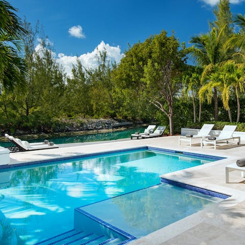 Swim in the outdoor private pool or enjoy a cocktail at the poolside seating area