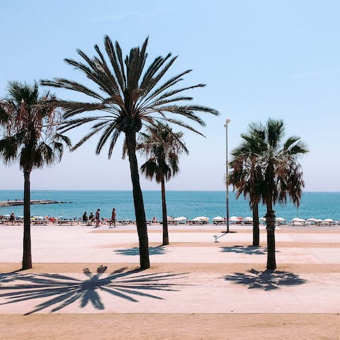 Spend the day sunbathing and swimming at Barceloneta Beach, 50 metres away