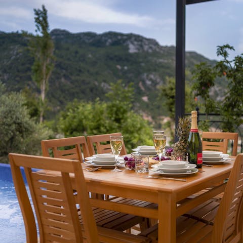 Clink glasses and toast to the sunset over the mountains of Islamlar