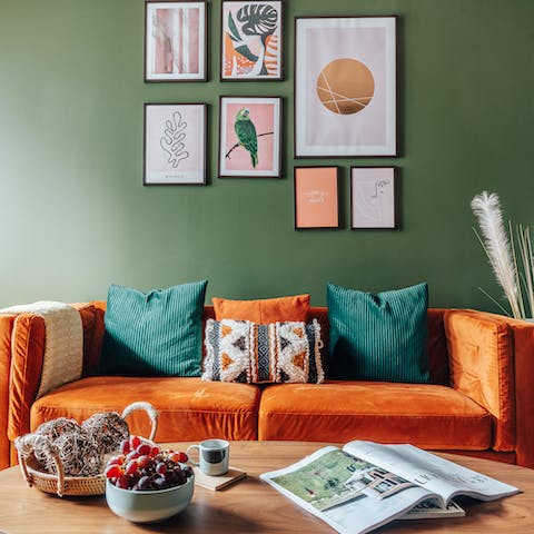 Kick back on the plush orange sofa after a long day in the city