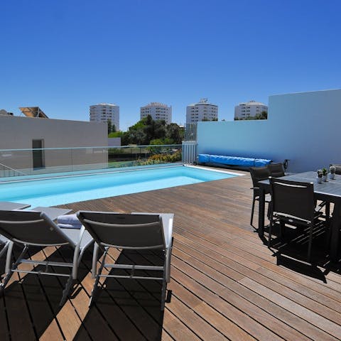 Laze on loungers in the sun or dine alfresco on the poolside deck