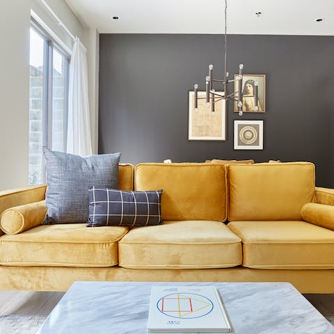 Unwind on the large mustard sofa with an evening cocktail