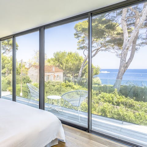 Enjoy blissful sea views while lounging in the bedroom