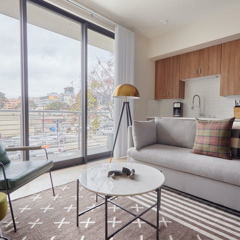 Relax in a bright, modern living room with floor-to-ceiling windows