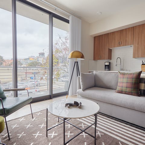 Relax in a bright, modern living room with floor-to-ceiling windows