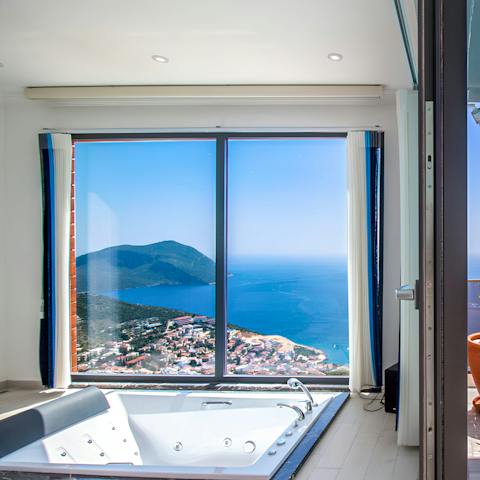 Admire breathtaking views from the Jacuzzi in the main bedroom