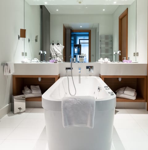 Take a long soak in the freestanding bathtub with massage features after a day exploring Paris