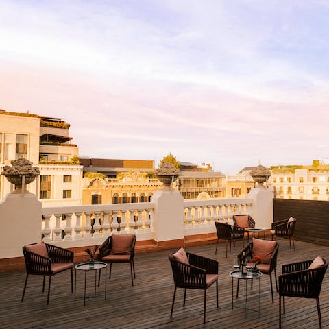 Sip a glass of natural orange wine from the rooftop terrace at sunset