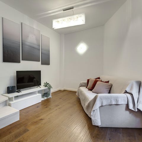 Relax in the chicly minimalist living room with a glass of Italian wine after a day of exploring the city