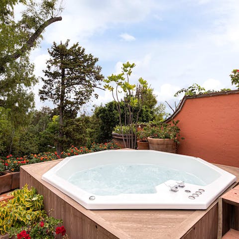 Soak in the hot tub surrounded by greenery