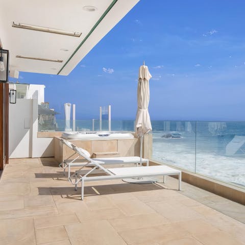 Spend days admiring the views from the sun loungers and the hot tub