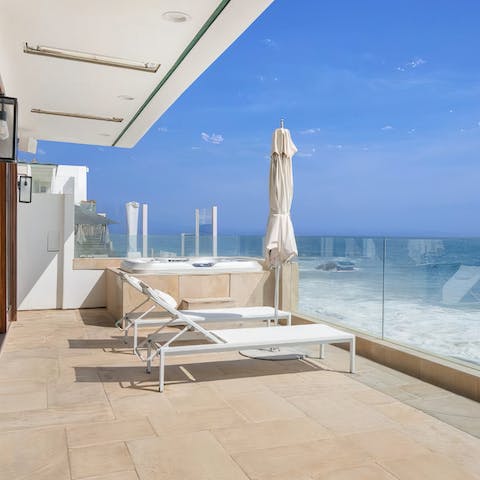 Spend days admiring the views from the sun loungers and the hot tub
