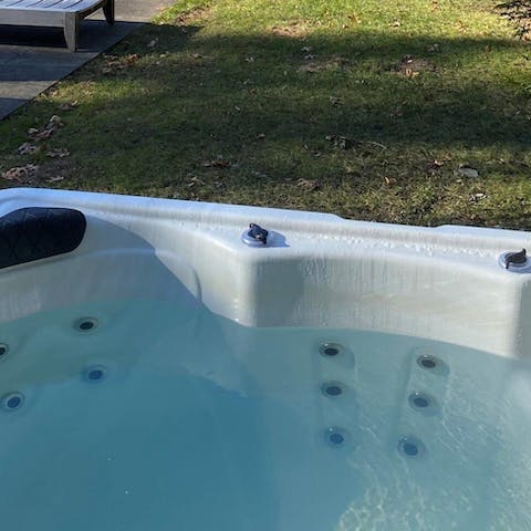 Relax and unwind in the outdoor hot tub 
