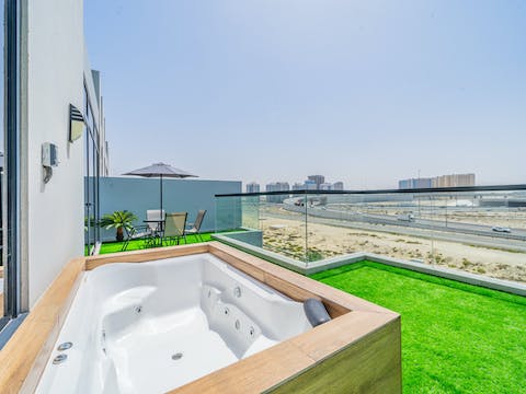 Relax in your private jacuzzi with views over the ever-changing skyline