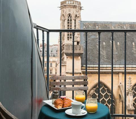 Enjoy a Parisian breakfast out on the balcony with church views