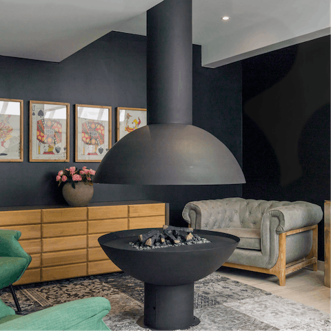 Relax around the shared lounge's indoor fire pit 