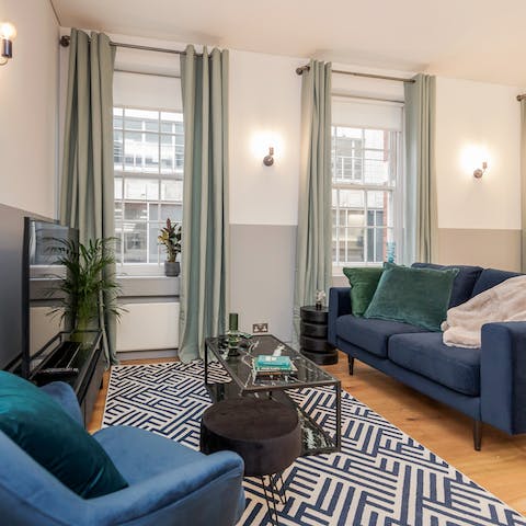 Relax in the bright living room with a glass of wine after a busy day of touring the city
