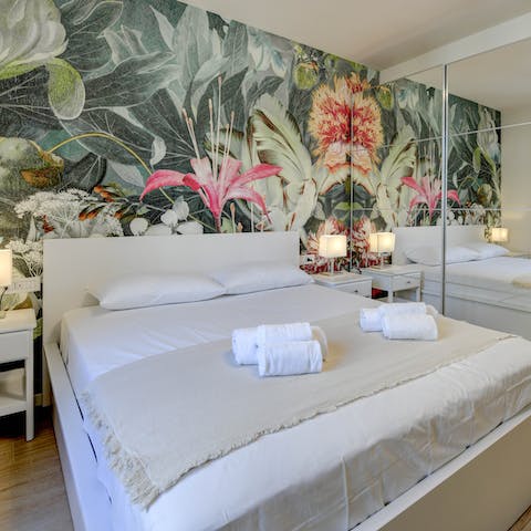 Get some rest in the main bedroom with its botanical wallpaper