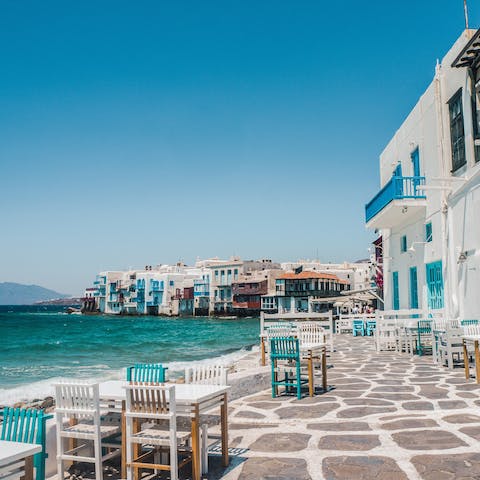 Drive fifteen minutes to reach the charming seafront cafés of Mykonos Town