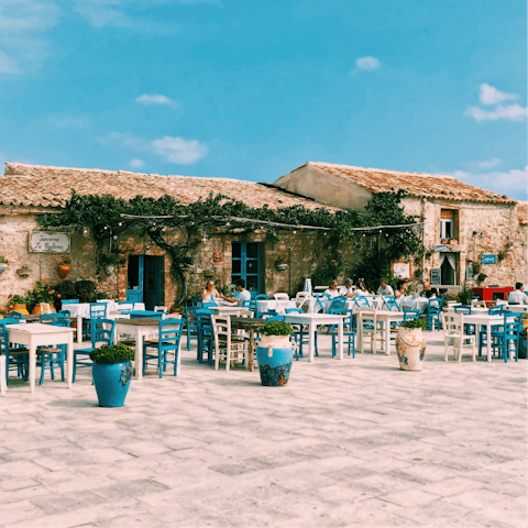Enjoy a spot of people-watching in Marzamemi's quaint piazza