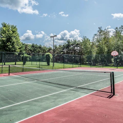 Practice your serve on the tennis court