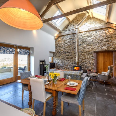Gather together for celebratory meals under the living room's tall beamed ceiling