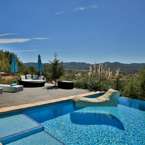 Wonder at the views of the surrounding hills from your private infinity pool
