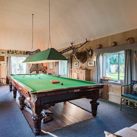 Play billiards while the kids run riot in their very own playroom