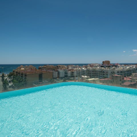 Take a dip in the rooftop pool overlooking the city 