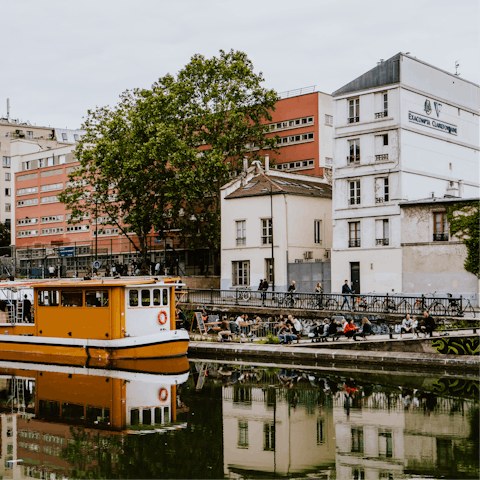 Explore Canal Saint-Martin's waterside cafés, a five-minute walk away
