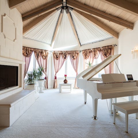 A grand white piano in the master bedroom