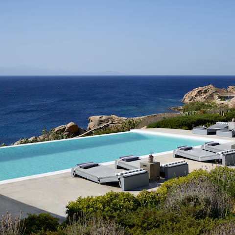Spend blissful days lounging by the two pools and admiring the views
