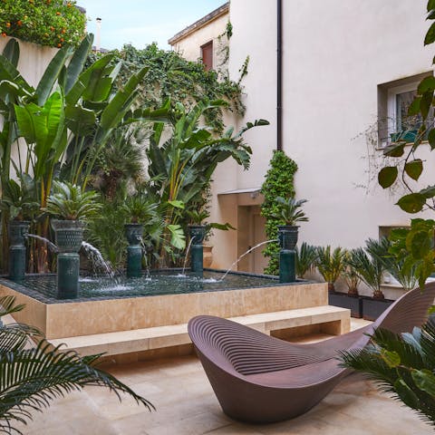 Get some fresh air in the shared courtyard garden with its fountains and lush planting