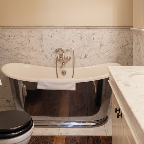 Soak away your troubles in luxurious marble bathroom with freestanding bath 